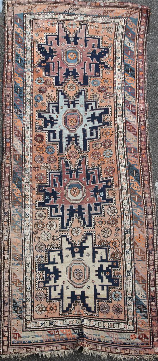 A Derbend apricot ground rug, c.1910, 9ft 6in by 3ft 6in.